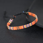 Bracciale brasiliano dell'amicizia intrecciato a mano arancione