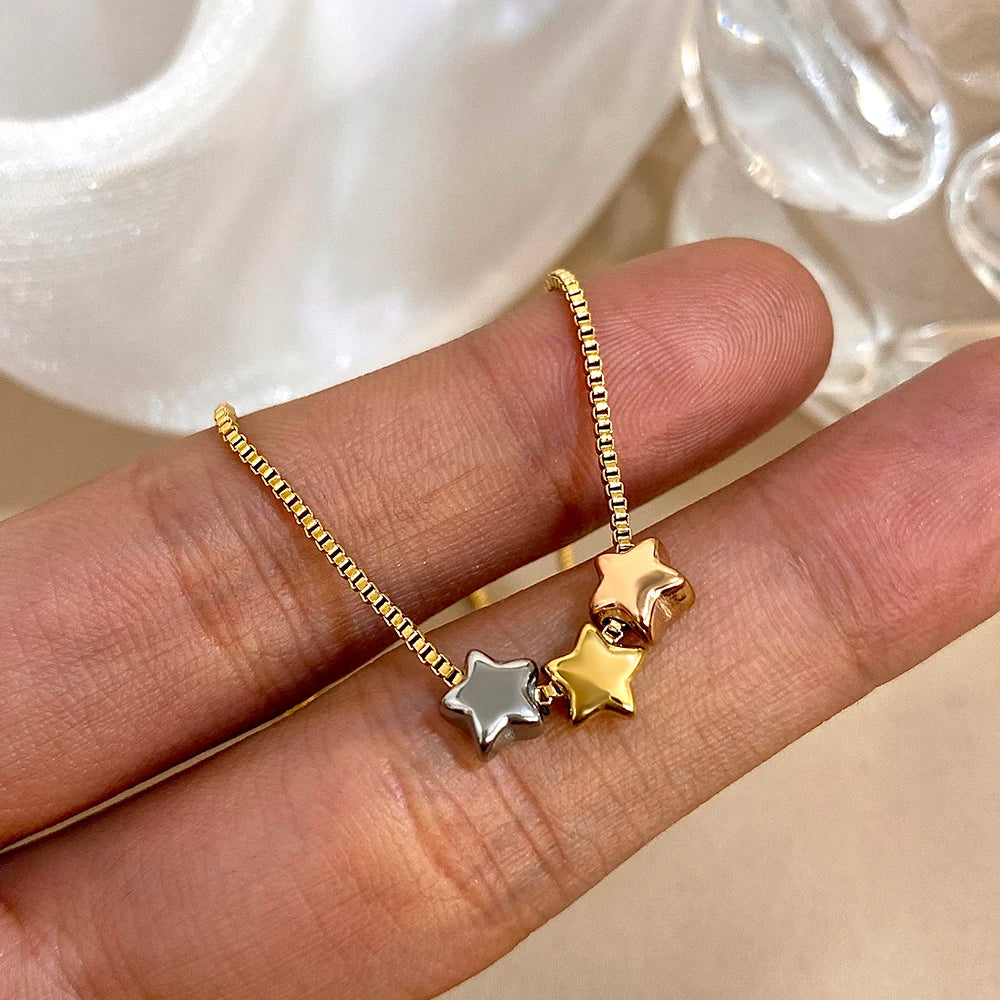 Collier avec pendentifs triple étoile bicolore